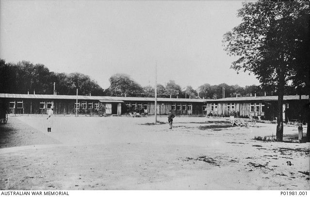 Exterior of the officers' barracks at the prisoner of war (POW) camp at Karlsruhe, Germany. Each barrack housed 32 officers with 8 officers to a room. The barracks were equipped with electric lights and the officers were attended by French orderlies who acted as batmen.
